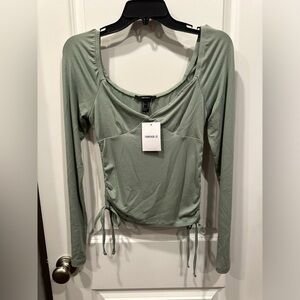 Long sleeve going out top with ties on the sides. Tag still on!